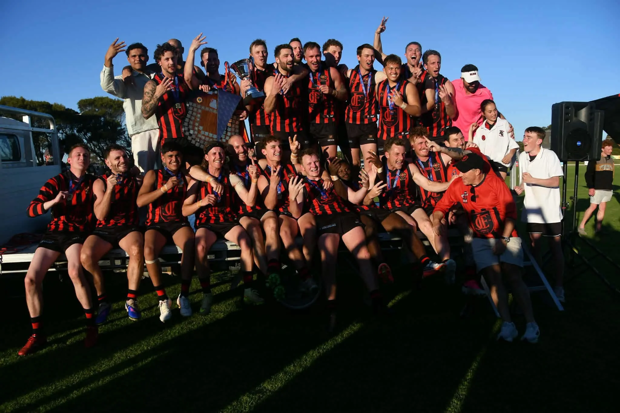 Jervois Bluds Football Club players celebrating together with their trophy